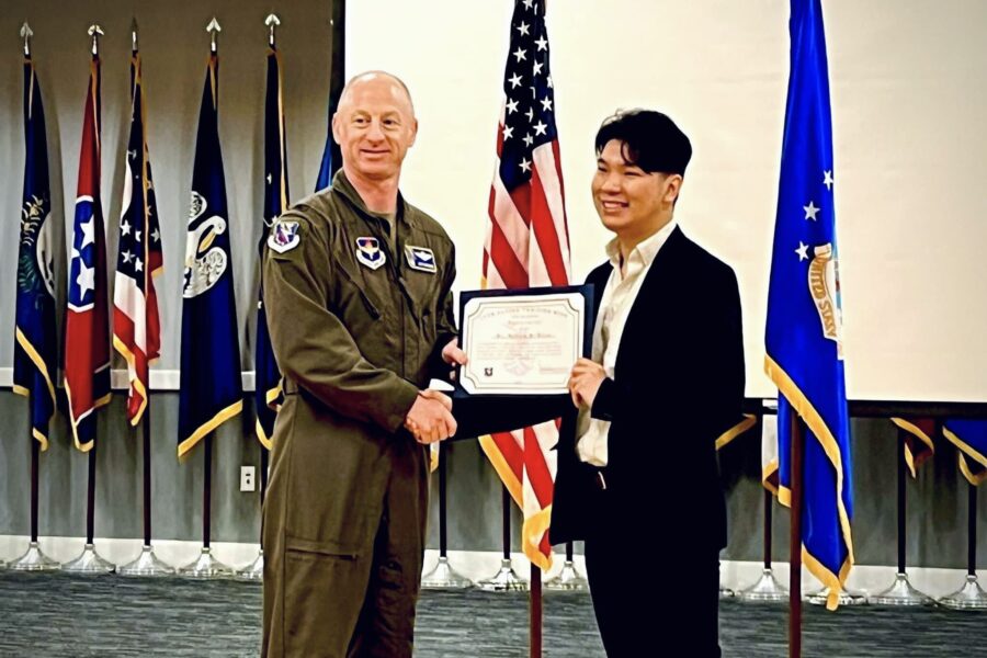 Teaching Dr. Pham Accepting Air Force Recognition